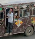 manstanding  in door of moving mutatu